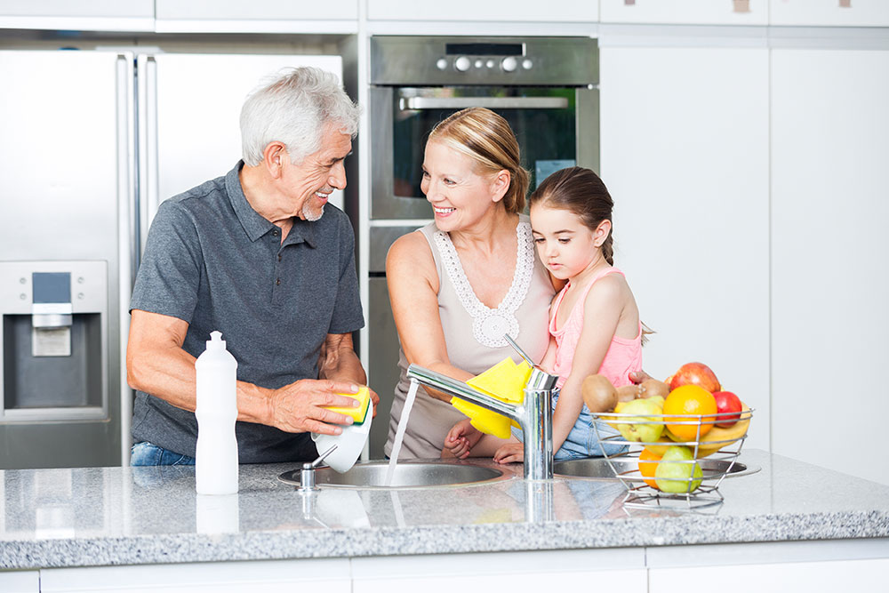 happy family washing the dishes together